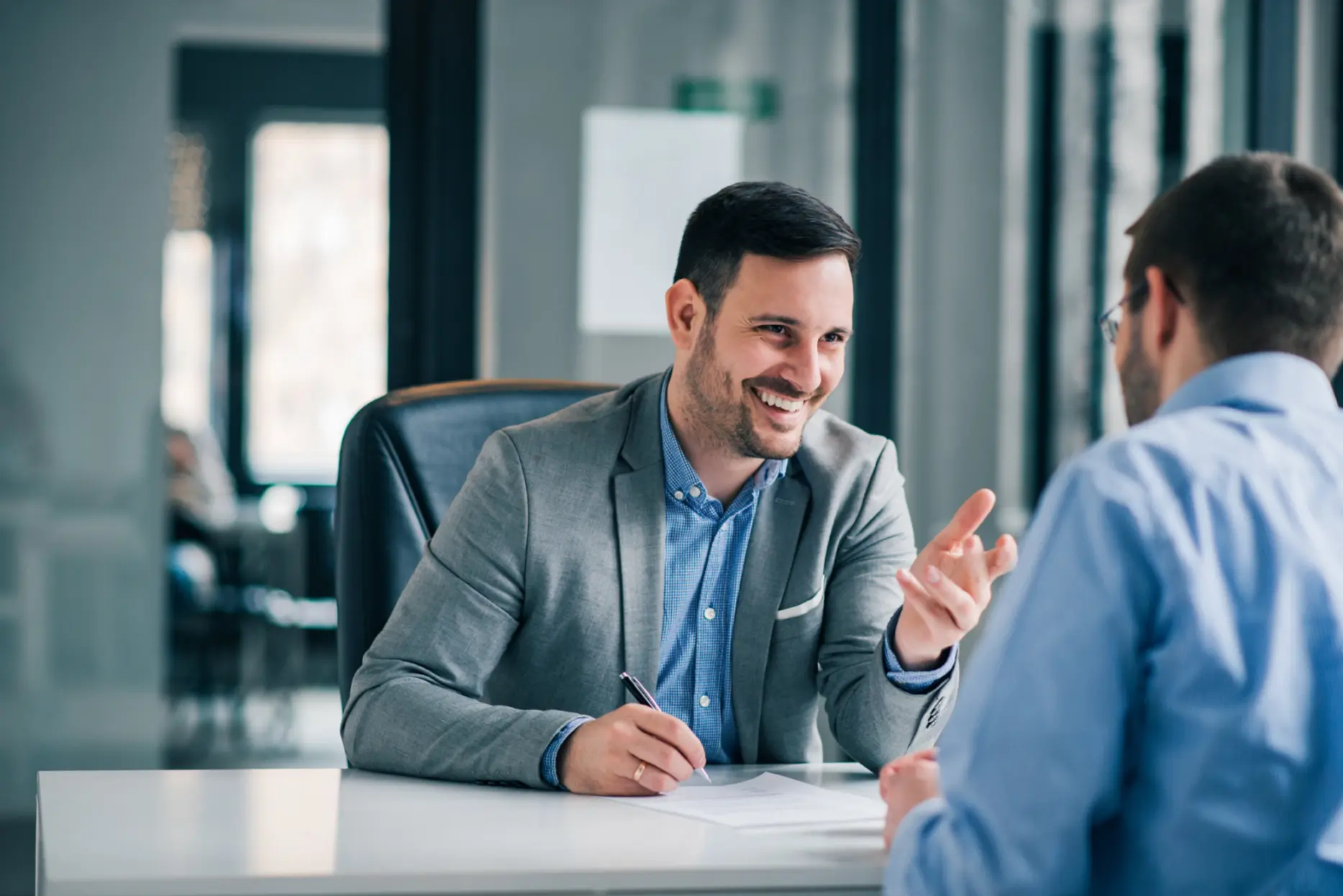 Man having a business meeting and signing a contract, recruitment or agreement.