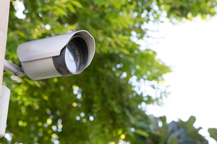 A security camera on the end of a mobile surveillance trailer. 
