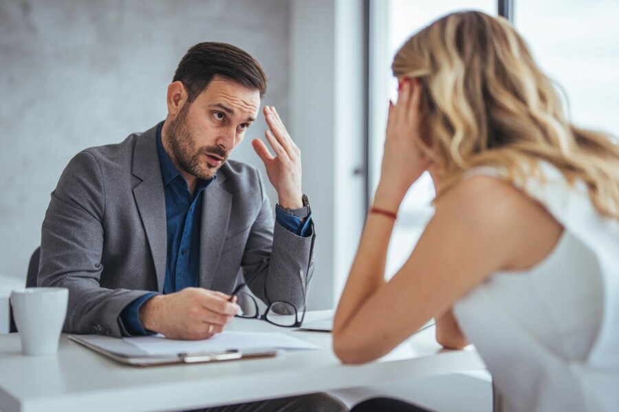 A distressed manager has a tense conversation with an employee who is struggling.