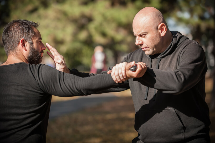 Security officers participating in supervised training covering basic self-defense techniques and the appropriate use of force.
